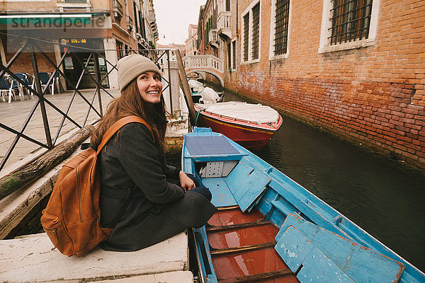 Frau am Kanal sitzend  Venedig  Italien