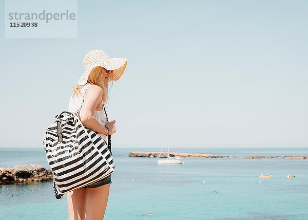 Frau am Meer mit Sonnenhut  Ciutadella  Menorca  Spanien