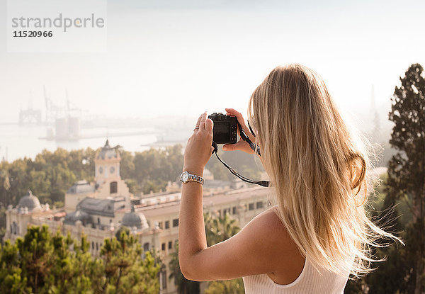 Frau mit Kamera bei einer Stadtrundfahrt  Malaga  Spanien