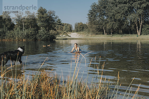 Niederlande  Schiermonnikoog  Frau mit Border Collie im See