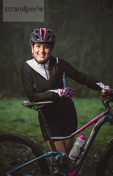 Porträt einer lächelnden Frau mit Mountainbike