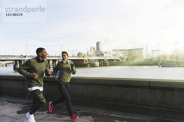 UK  London  Mann und Frau laufen auf dem Riverwalk