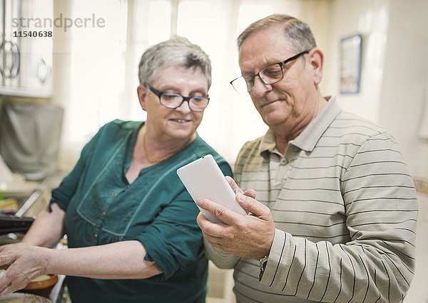 Seniorenpaar sucht Smartphone zu Hause
