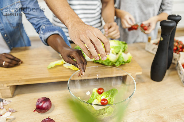 Übergabe der Salatschüssel in der Küche