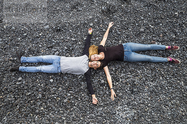 Entspanntes junges Paar auf Steinen liegend