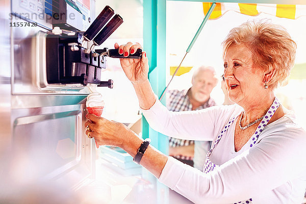 Senior Unternehmerin serviert Eis am Speisewagen