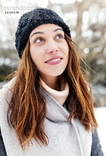 Junge Frau im Winter im Freien nach oben schauend