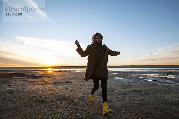 Frau genießt Strand bei Sonnenuntergang