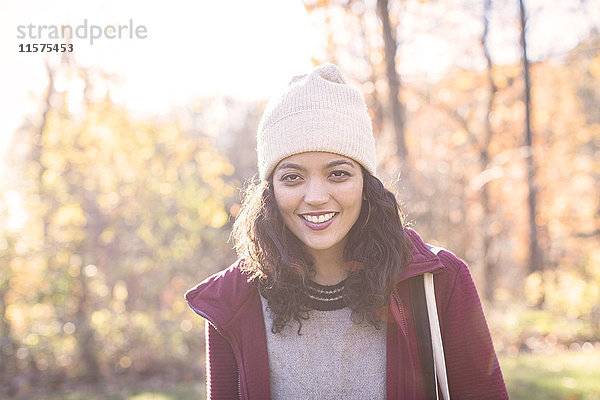 Porträt einer jungen Frau mit Strickmütze im Herbst