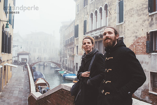 An die neblige Kanalbrücke gelehntes Ehepaar  Venedig  Italien
