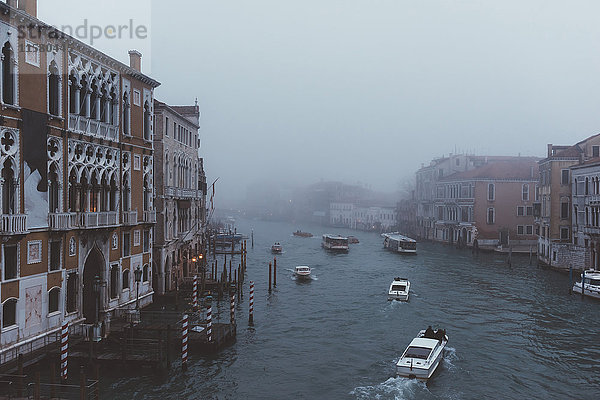 Erhöhte Ansicht von Motorbooten auf nebligem Kanal  Venedig  Italien