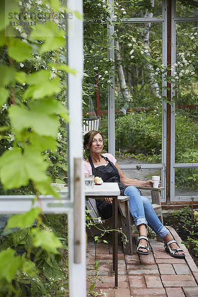 Gärtnerin ruht im Glashaus