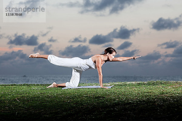 Frau in Yoga-Pose im Freien