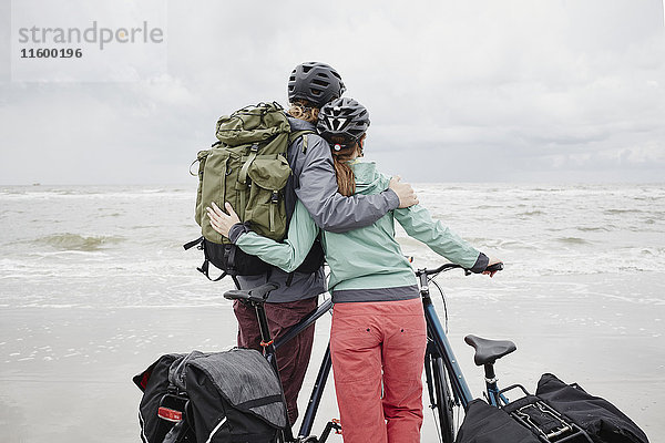 Deutschland  Schleswig-Holstein  St. Peter-Ording  Paar mit Fahrrädern am Strand