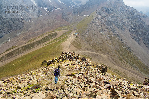 Kaukasischer Mann beim Wandern auf Bergfelsen