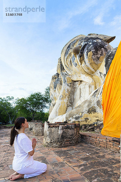 Asiatische Frau beim Beten im Tempel