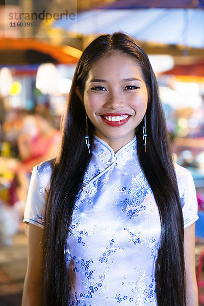 Porträt einer lächelnden asiatischen Frau in traditioneller Kleidung