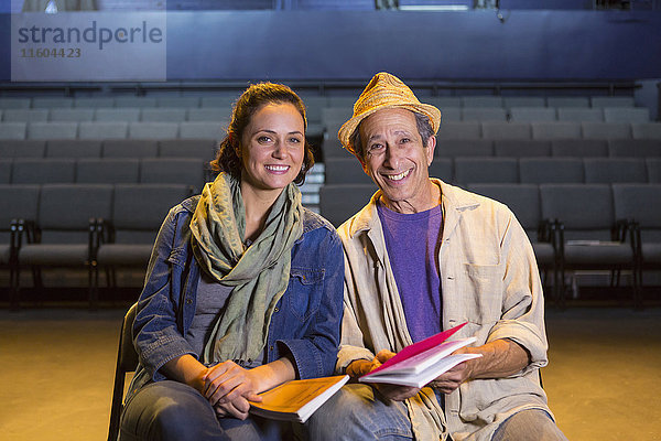 Porträt von kaukasischen Schauspielern mit Drehbüchern im Theater