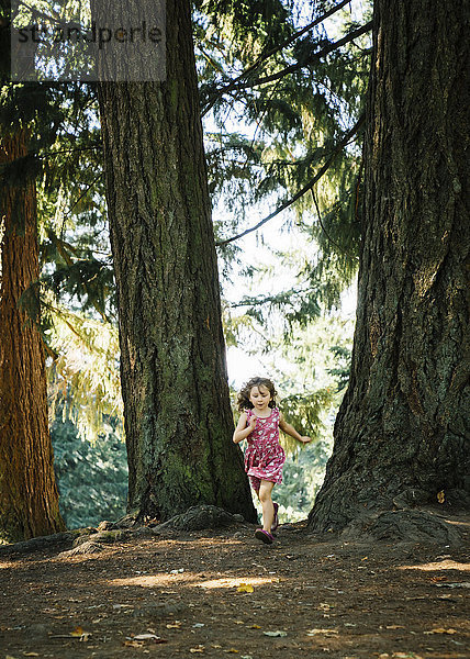 Kaukasisches Mädchen läuft im Wald