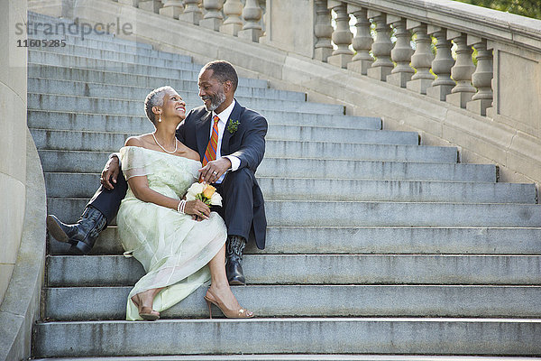 Schwarzes Paar sitzt auf Steintreppe