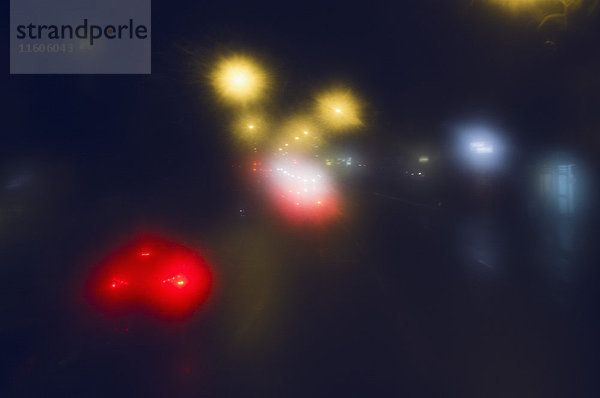 Defokussiertes Bild von Autos auf der Stadtstraße bei Nacht