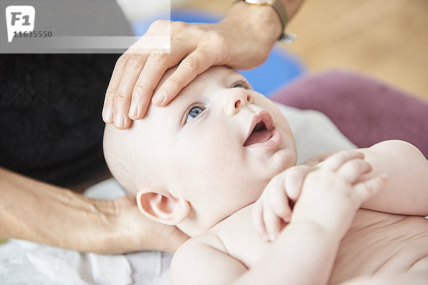 Reportage über eine Praxis für Physiotherapie und Osteopathie in Lyon  Frankreich. Osteopathiesitzung mit einem Baby zur Unterstützung der Verdauung und zur Wiederherstellung des Gleichgewichts des Skeletts  um Beschwerden zu lindern.