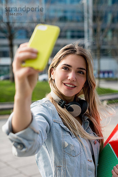 Junge Frau  im Freien  nimmt Selfie mit Smartphone