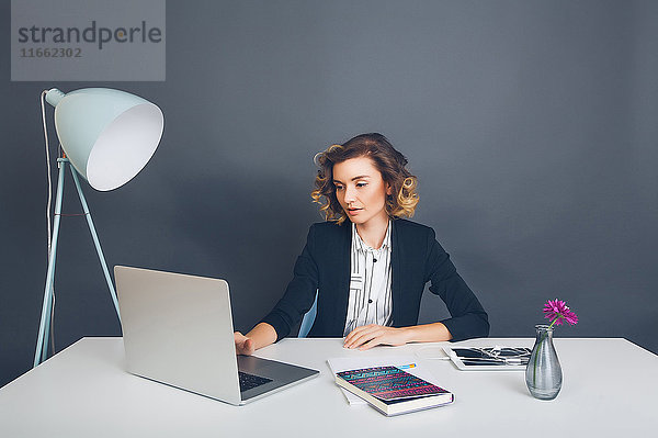 Frau am Schreibtisch mit Laptop