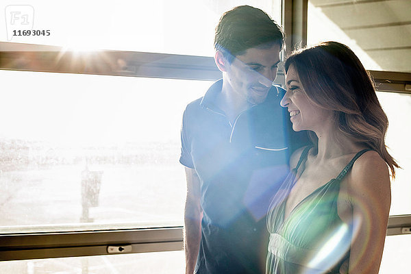 Junges Paar am Fenster im Sonnenlicht