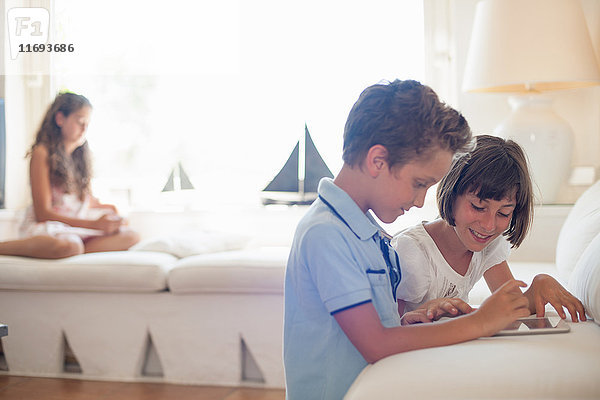 Kinder benutzen gemeinsam einen Tablet-Computer