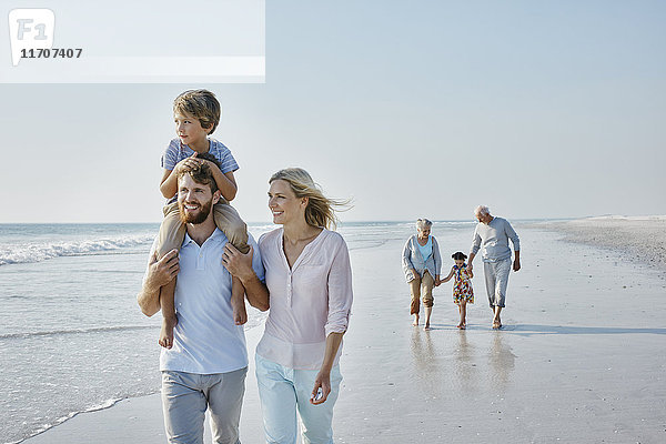Glückliche Großfamilie beim Strandspaziergang