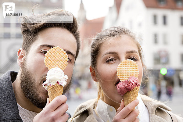 Lustiges Porträt eines jungen Paares beim Eis essen