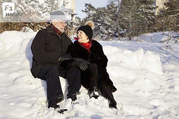 Älteres Paar beim Spaziergang im Wald im Winter