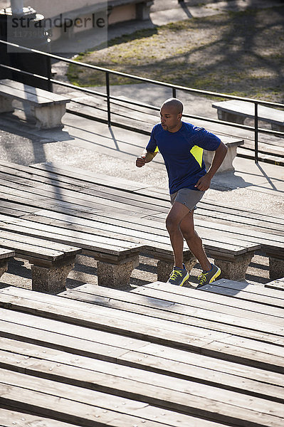 Mann rennt die Stufen im Stadion hoch