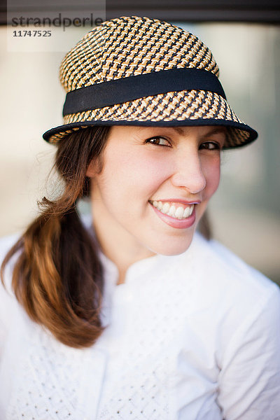 Mittlere erwachsene Frau mit Hut und Lächeln  Porträt