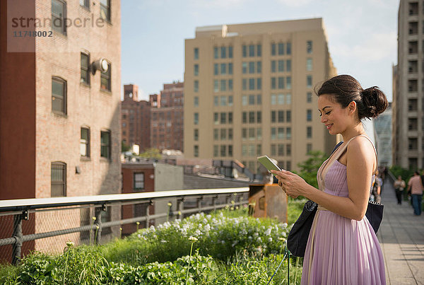 Mittelgroße erwachsene Frauen mit digitalem Tablet im High Line Park  New York City