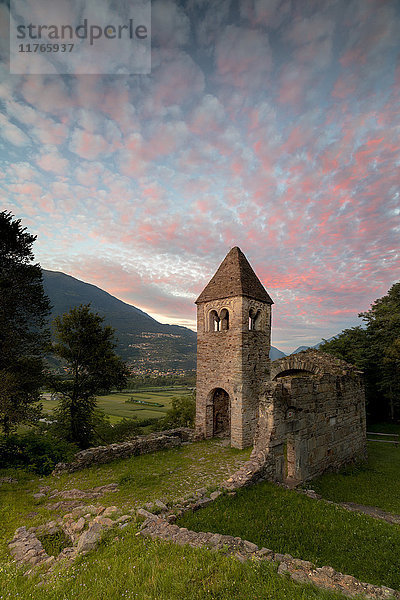 Rosa Wolken bei Sonnenuntergang an der alten Abtei San Pietro in Vallate  Piagno  Provinz Sondrio  Unteres Valtellina  Lombardei  Italien  Europa