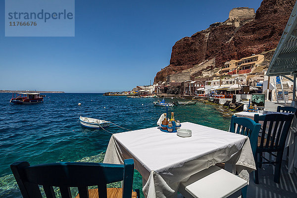 Ein Tisch mit Aussicht in einem der Fischrestaurants in der Ammoudi-Bucht (Amoudi) am Fuße der Stufen unterhalb von Oia  Santorin  Kykladen  Griechische Inseln  Griechenland  Europa