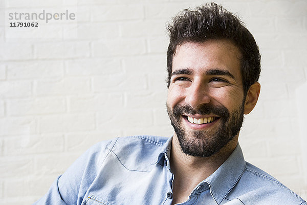 Portrait eines lachenden jungen Mannes mit Bart