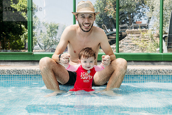 Glückliches kleines Mädchen im Schwimmbad mit Vater