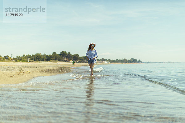 Frau beim Spaziergang am Meer