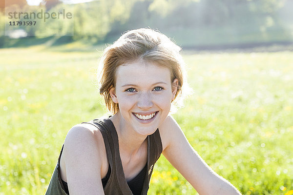 Porträt einer lächelnden jungen Frau in der Natur