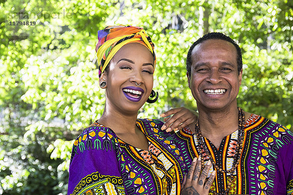 Porträt der lachenden jungen Frau und ihres Vaters in traditioneller brasilianischer Kleidung