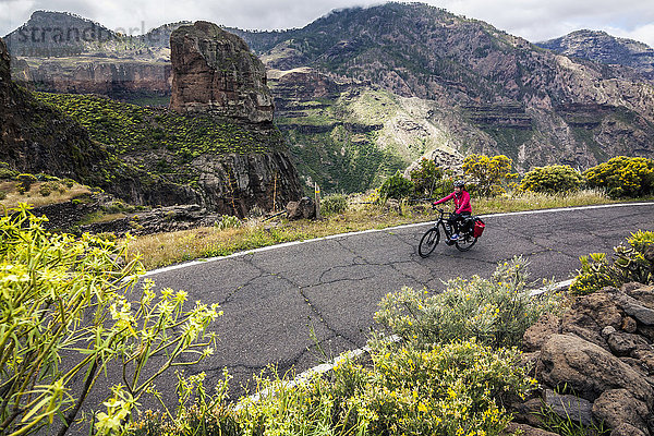 Mountainbiker fährt Elektrofahrrad auf Bergstraße