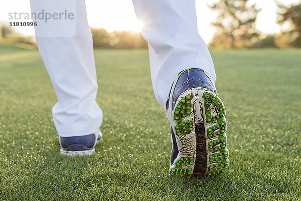 Gras klebt am Schuh eines Golfers