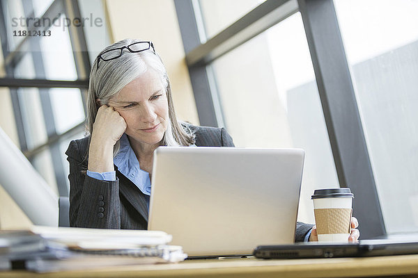 Frustrierte kaukasische Geschäftsfrau mit Laptop