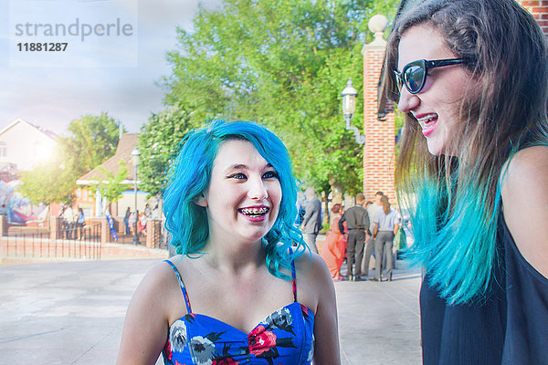 Porträt von zwei Freundinnen mit blauen Haaren  lachend