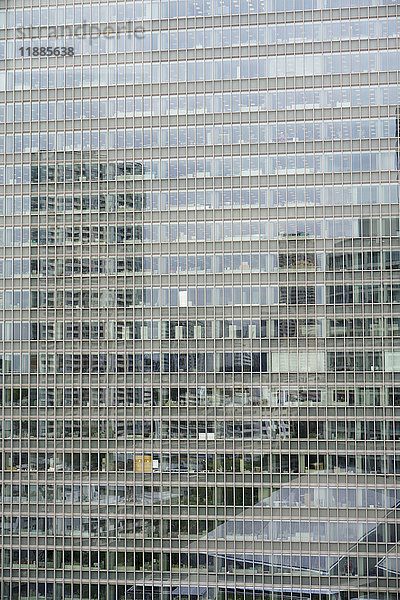 Vollbildaufnahme eines modernen Bürogebäudes mit Spiegelung