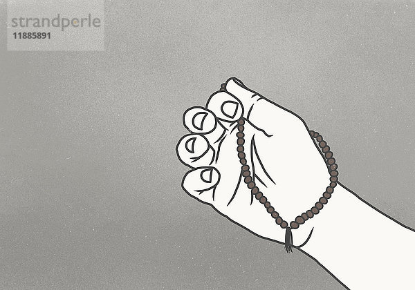 Abgeschnittenes Bild der Hand mit Gebetsperlen vor grauem Hintergrund