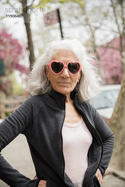 Ältere Frau mit herzförmiger Sonnenbrille